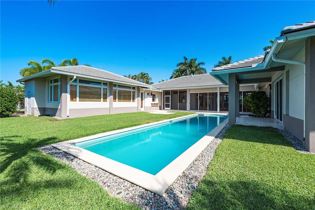 550 Starboard Drive Naples, FL 34103 - Photo 25 of 28 a view of a house with a yard patio and swimming pool