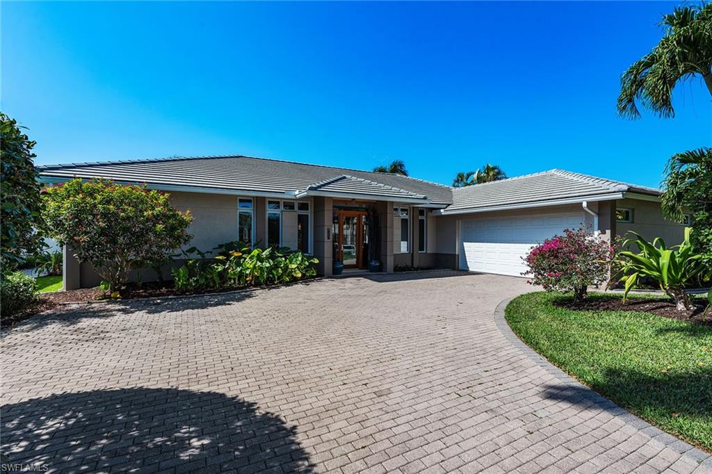 550 Starboard Drive Naples, FL 34103 - Photo 28 of 28 a front view of a house with a yard
