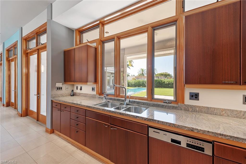 550 Starboard Drive Naples, FL 34103 - Photo 4 of 28 a bathroom with a sink windows and a bathtub