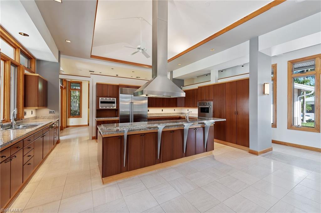 550 Starboard Drive Naples, FL 34103 - Photo 5 of 28 a large kitchen with stainless steel appliances granite countertop a large counter top a stove and a refrigerator