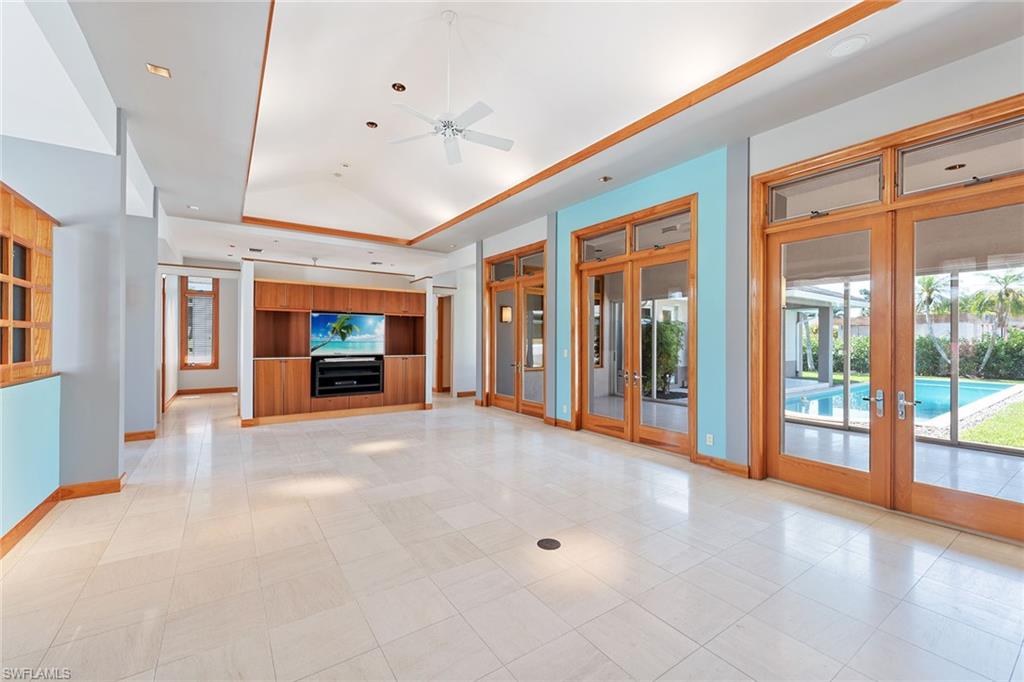550 Starboard Drive Naples, FL 34103 - Photo 6 of 28 a view of an empty room with a fireplace and a window