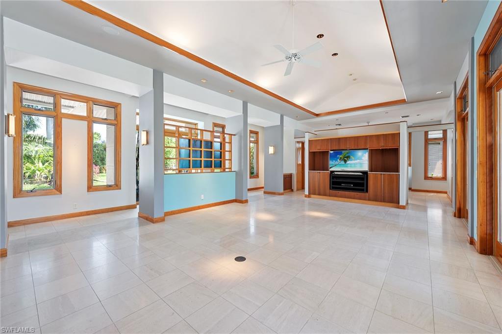 550 Starboard Drive Naples, FL 34103 - Photo 7 of 28 a view of an empty room with a fireplace and a window
