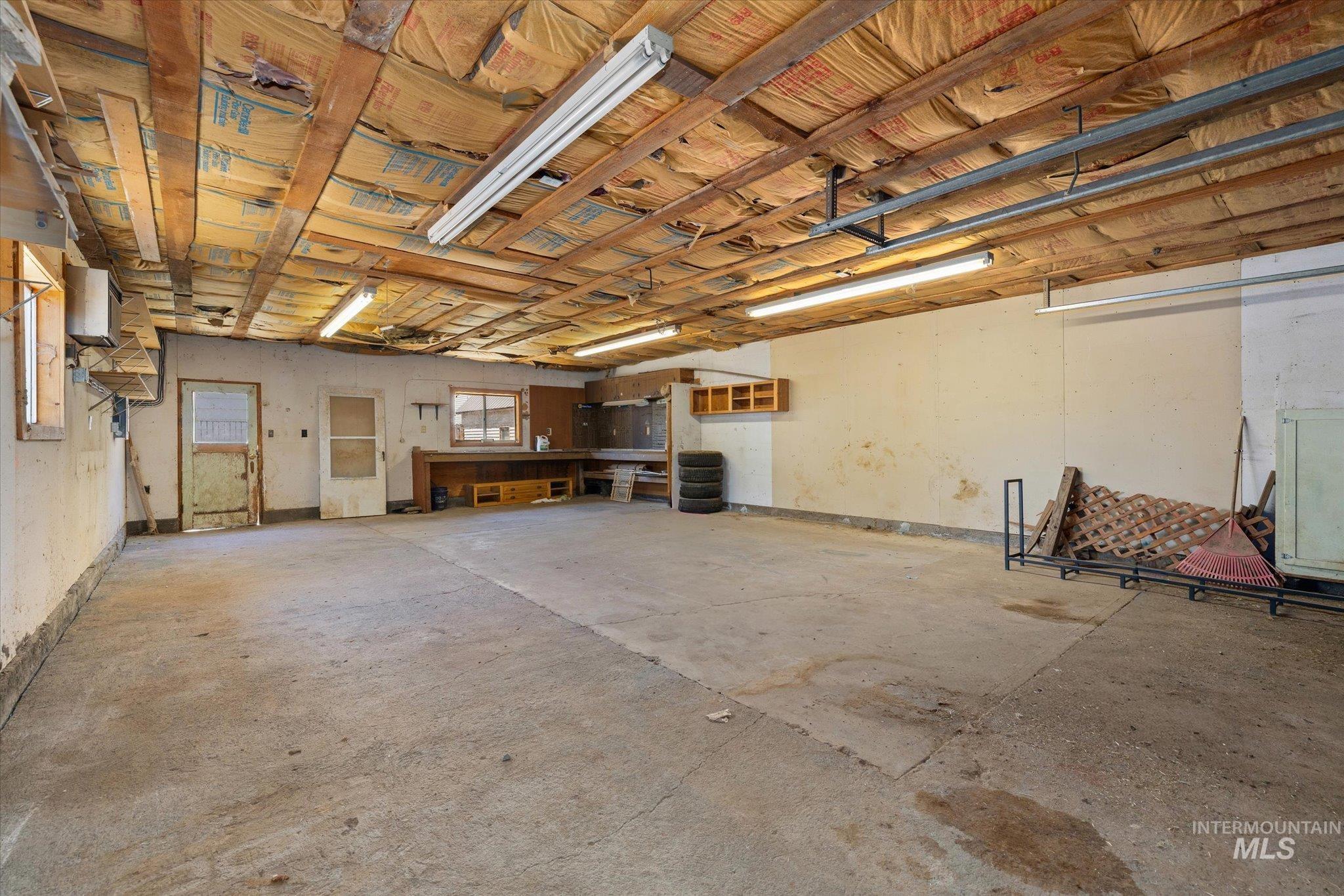 918 West 3rd Street Weiser, ID 83672 - Photo 35 of 36 Spacious garage with concrete flooring and exposed beam ceiling