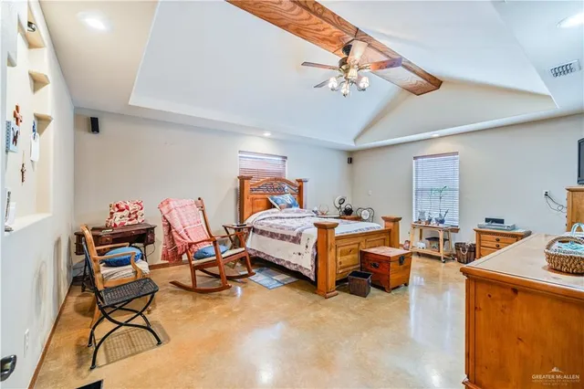 a bedroom with furniture and a chandelier