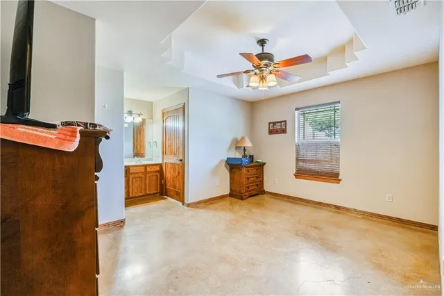a view of a livingroom with a chandelier furniture and a ceiling fan