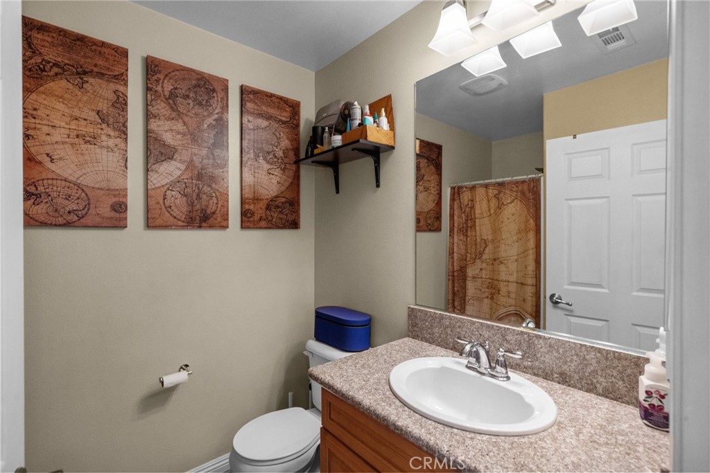 26135 Gravett Place Saugus, CA 91350 - Photo 13 of 31 a bathroom with a toilet sink and mirror