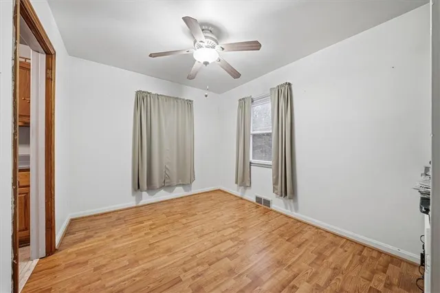 a view of a livingroom with a ceiling fan and wooden floor