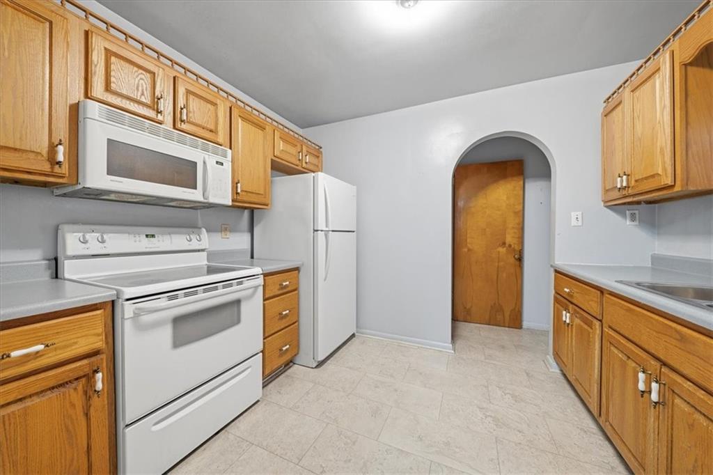 828 Dearborn Street Baden, PA 15005 - Photo 14 of 26 a kitchen with stainless steel appliances granite countertop a stove and a refrigerator