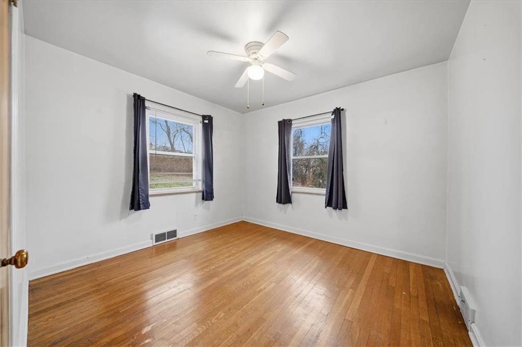 828 Dearborn Street Baden, PA 15005 - Photo 18 of 26 a view of an empty room with window and wooden floor