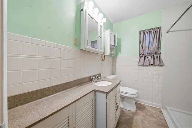 a bathroom with a sink a toilet and mirror