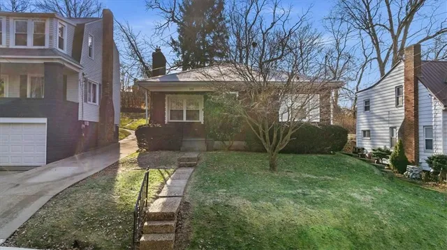 a view of a chair and table in backyard of the house