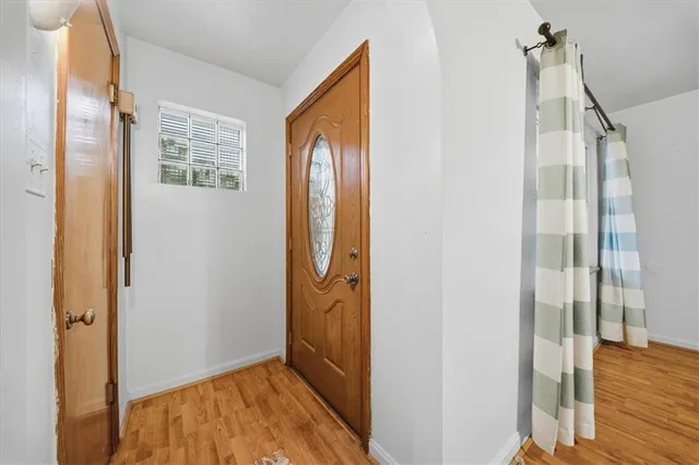 a view of hallway with wooden floor and stairs