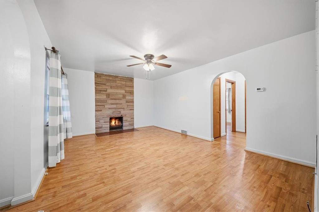 828 Dearborn Street Baden, PA 15005 - Photo 8 of 26 a view of an empty room with a fireplace and a window