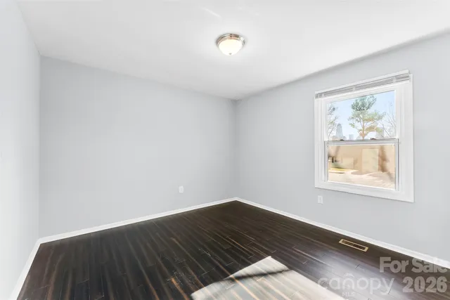 a view of an empty room and wooden floor