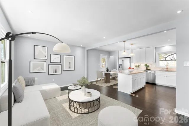 a living room with furniture and a dining table with wooden floor