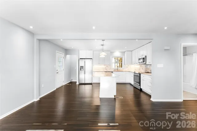 a view of kitchen with furniture and wooden floor