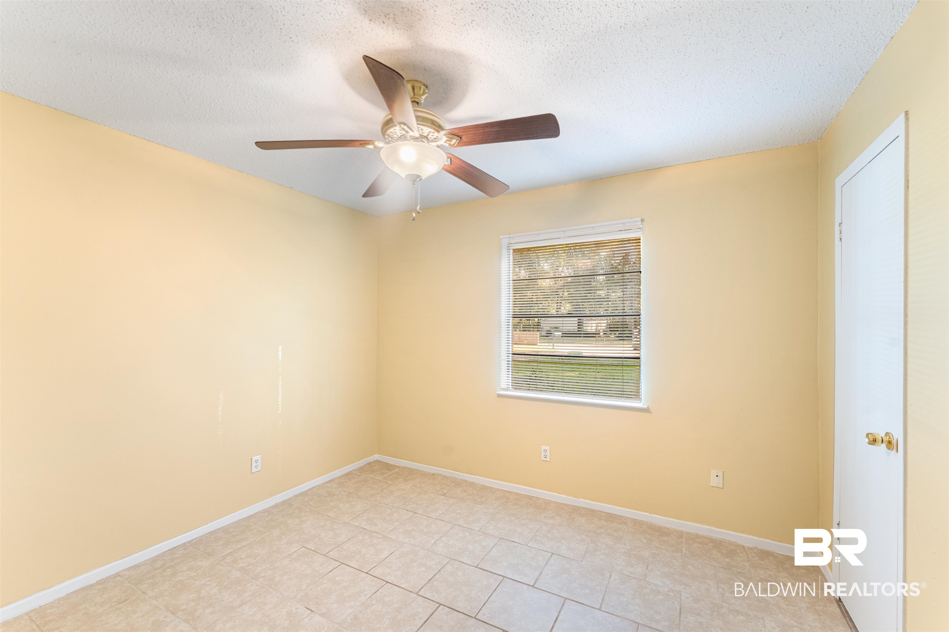 5551 Springer Court Theodore, AL 36582 - Photo 33 of 37 Empty room with a textured ceiling, light tile patterned floors, and ceiling fan