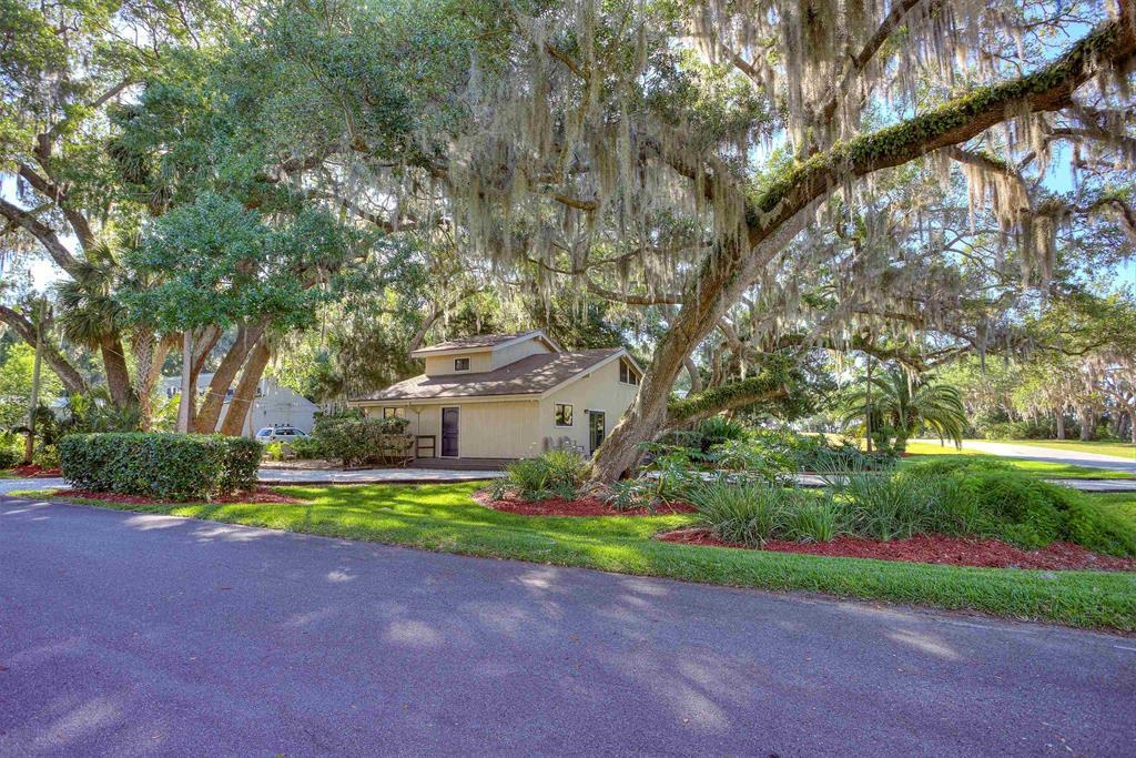100 Saturn Road St. Augustine, FL 32086 - Photo 1 of 29 a view of a house with a yard and large trees