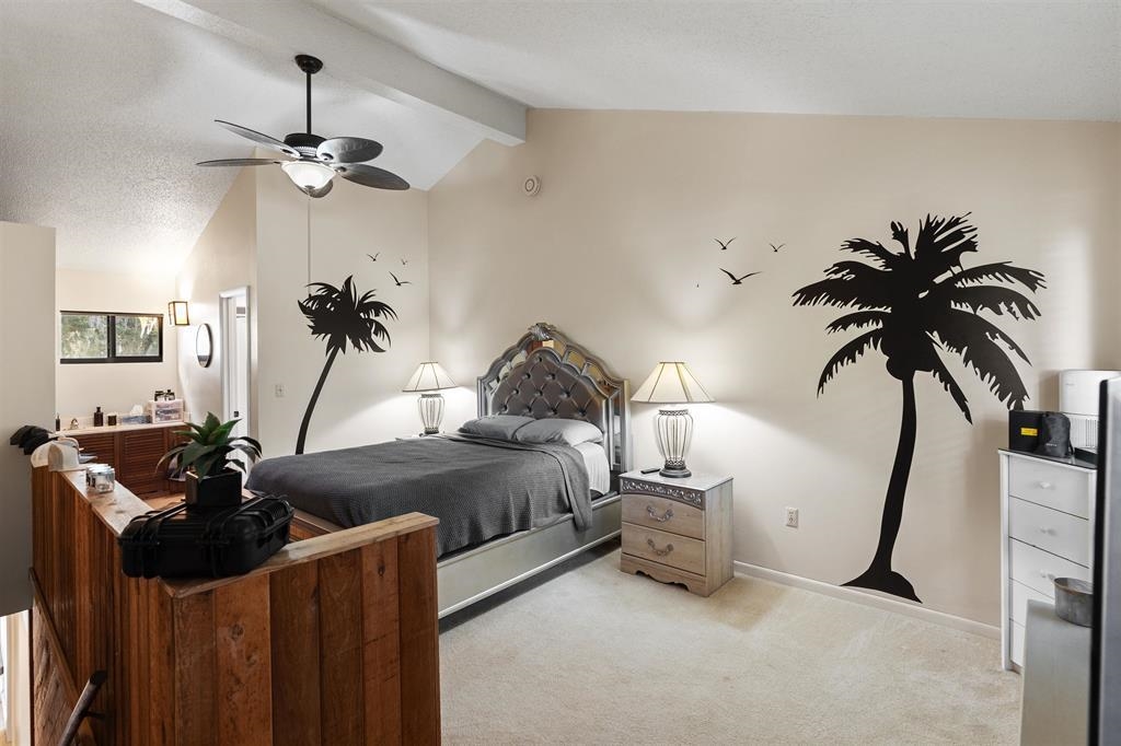 100 Saturn Road St. Augustine, FL 32086 - Photo 12 of 29 a bedroom with a bed and a chandelier