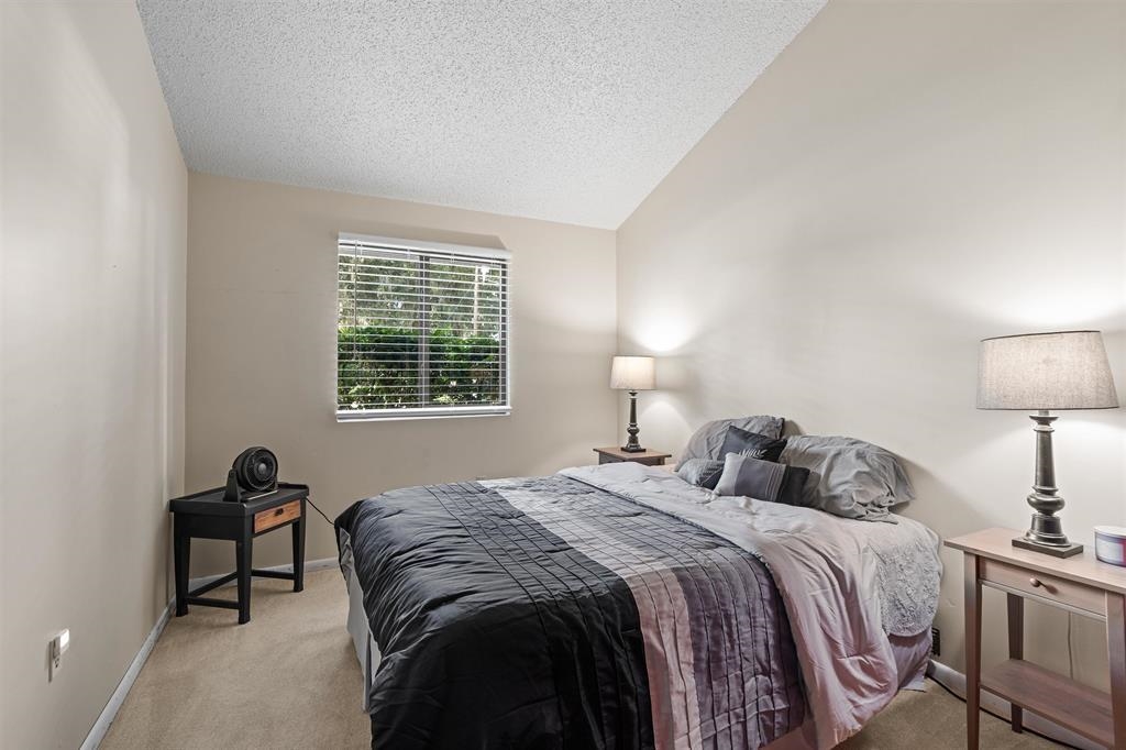 100 Saturn Road St. Augustine, FL 32086 - Photo 14 of 29 a bedroom with a bed and a lamp