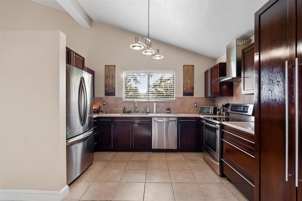 100 Saturn Road St. Augustine, FL 32086 - Photo 3 of 29 a kitchen with stainless steel appliances granite countertop a refrigerator a stove a sink and dishwasher