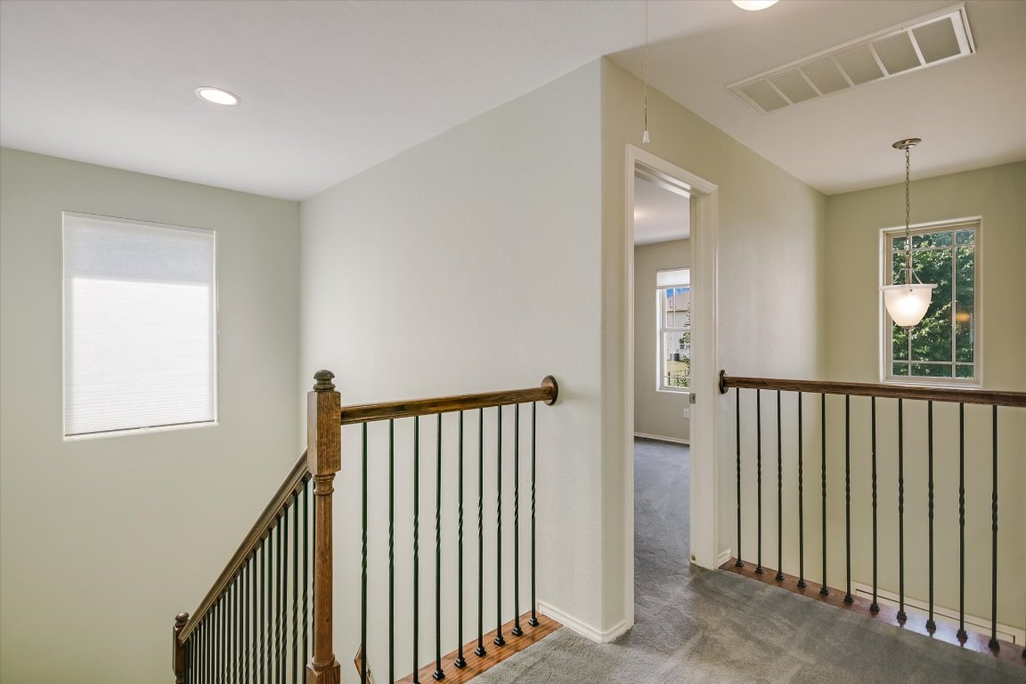 6203 Aviara Drive Austin, TX 78735 - Photo 13 of 33 a view of a hallway with windows and stairs