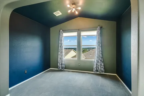 an empty room with a empty space and windows