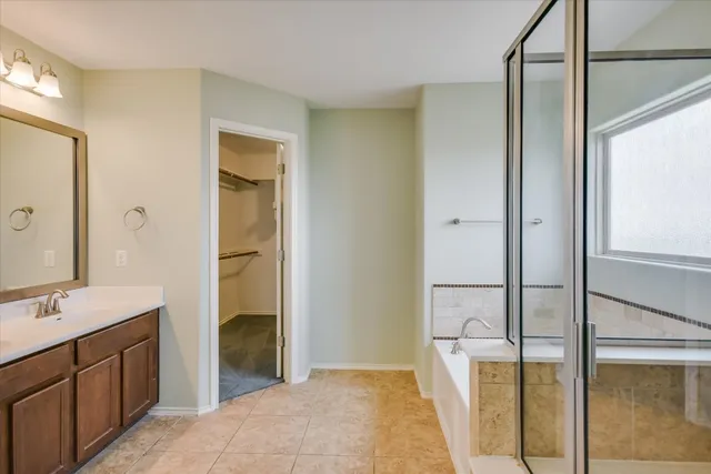a bathroom with a double vanity sink and mirror