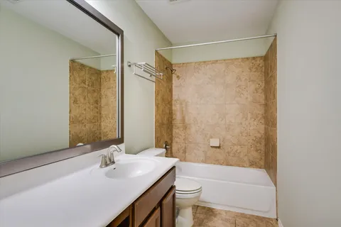 a bathroom with a sink mirror toilet and bathtub