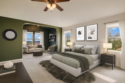 a bedroom with a large bed and a chandelier