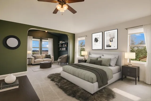 a bedroom with a large bed and a chandelier