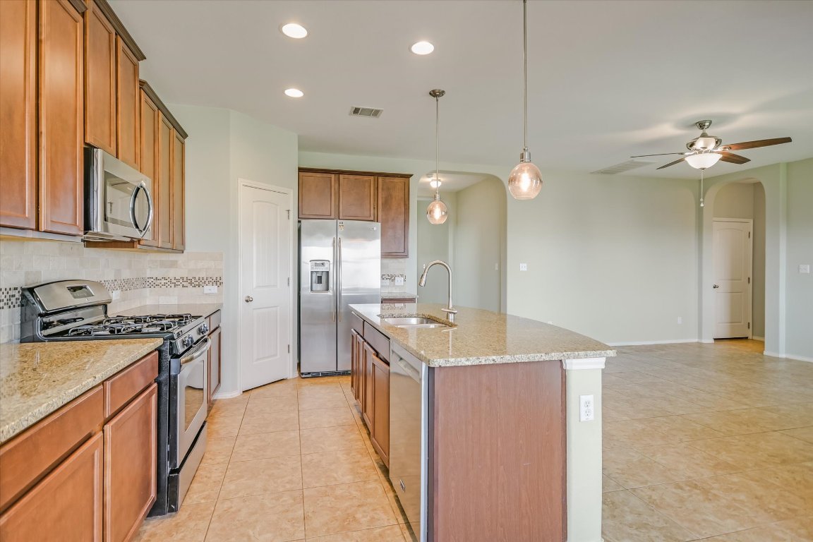 6203 Aviara Drive Austin, TX 78735 - Photo 7 of 33 a kitchen with granite countertop a sink a counter top space stove and cabinets