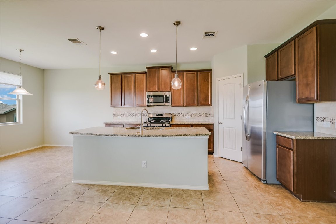 6203 Aviara Drive Austin, TX 78735 - Photo 8 of 33 a view of kitchen with stainless steel appliances granite countertop a stove top oven a sink and a refrigerator