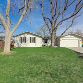 a view of house with yard and green space