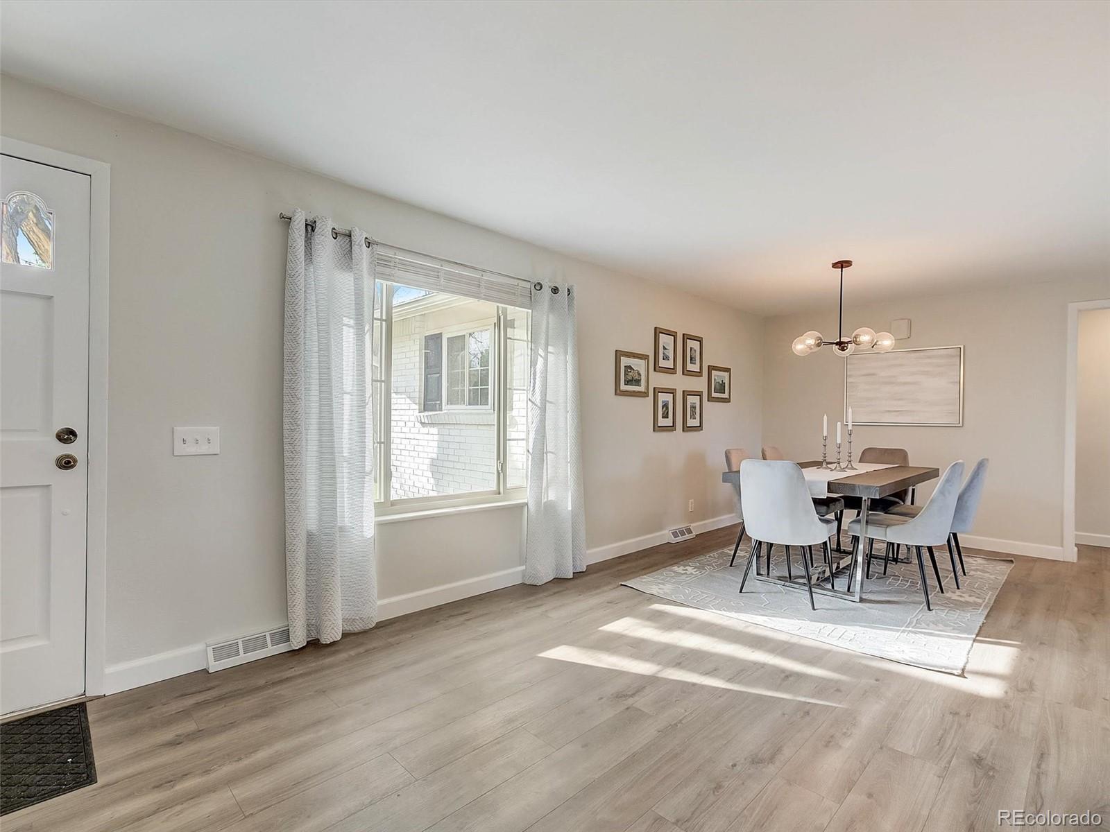 6432 South Birch Circle Centennial, CO 80121 - Photo 16 of 40 a view of a dining room with furniture and chandelier