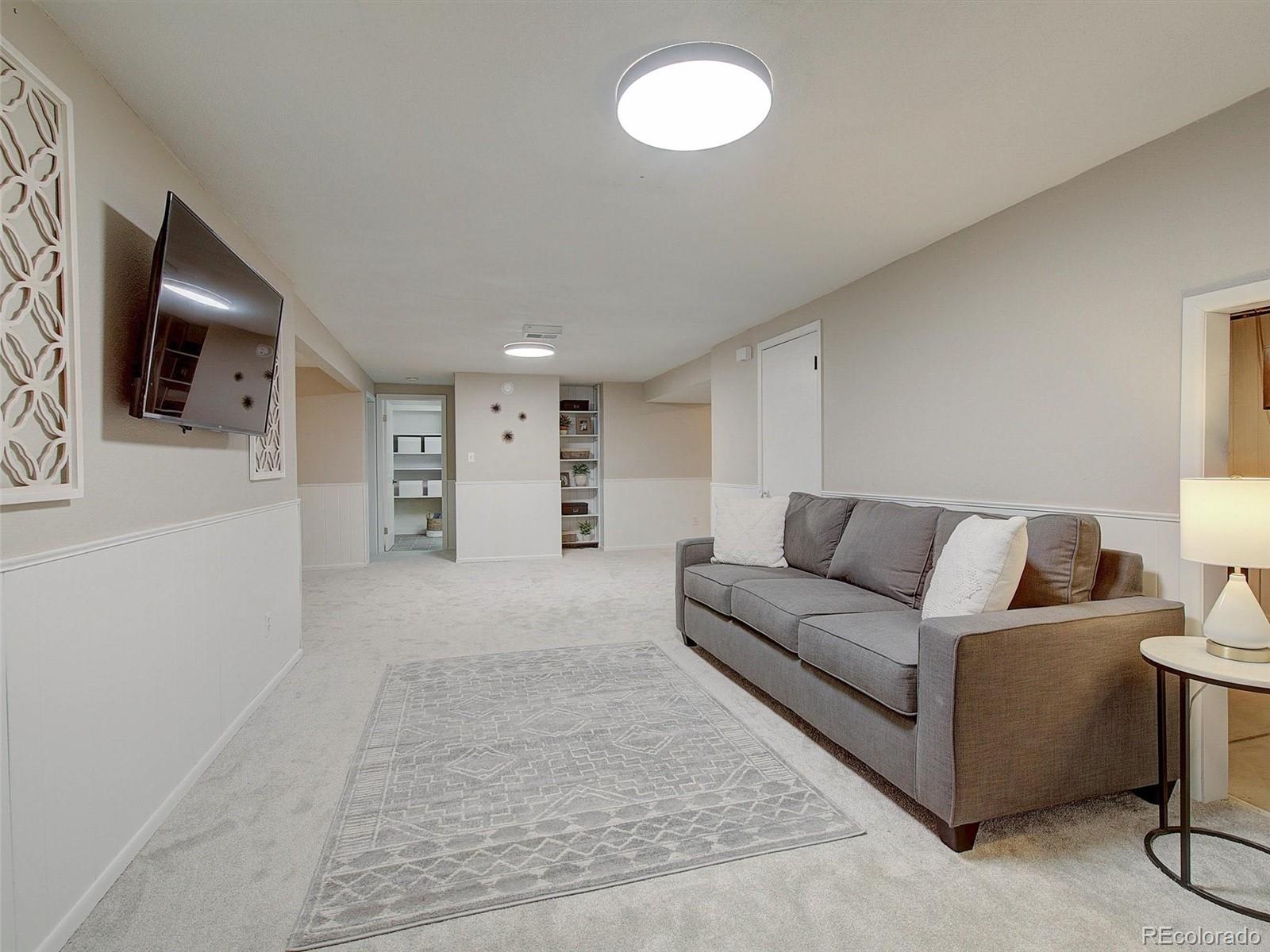 6432 South Birch Circle Centennial, CO 80121 - Photo 26 of 40 a living room with furniture and a flat screen tv