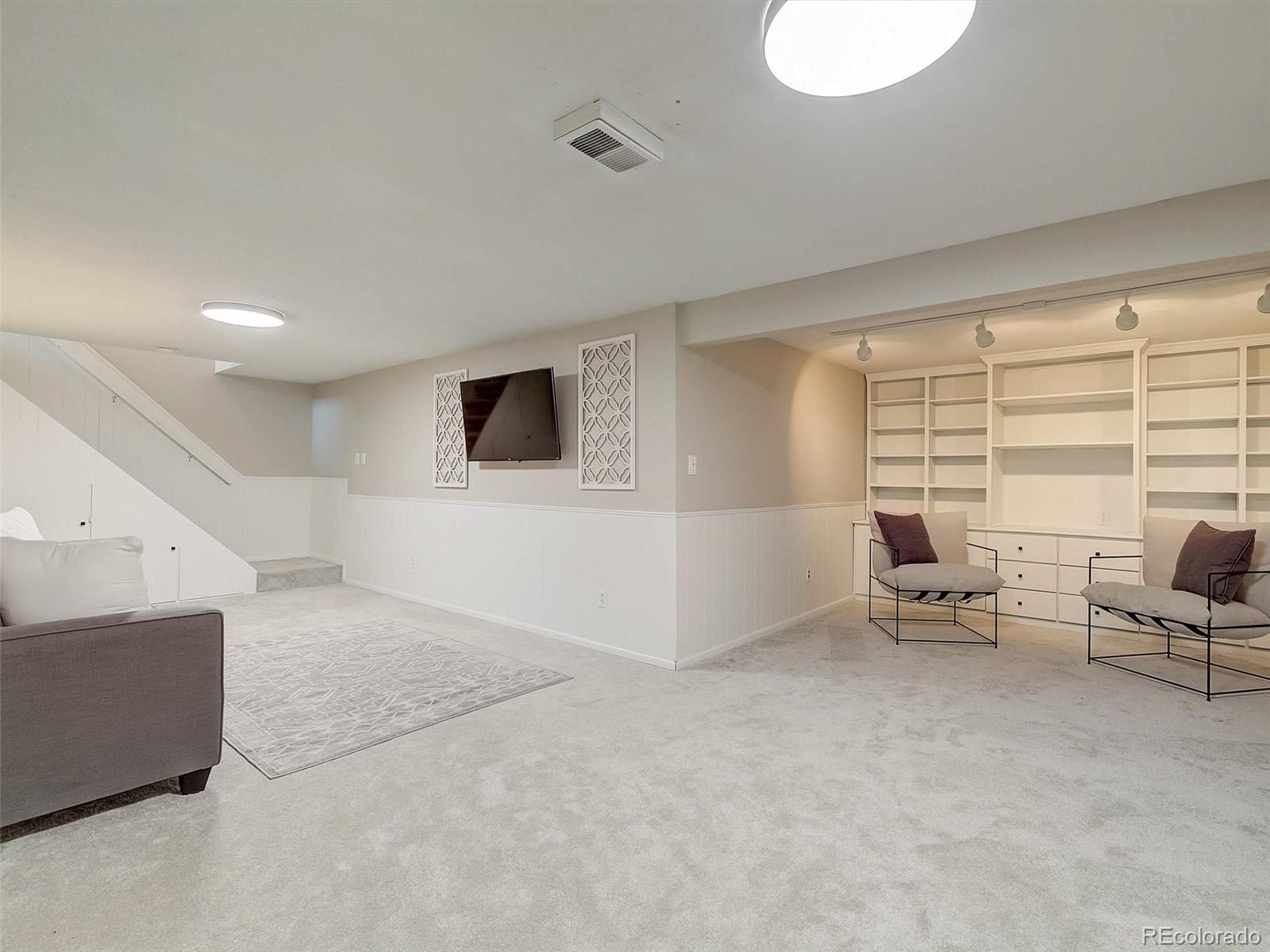 6432 South Birch Circle Centennial, CO 80121 - Photo 28 of 40 a living room with furniture and a flat screen tv