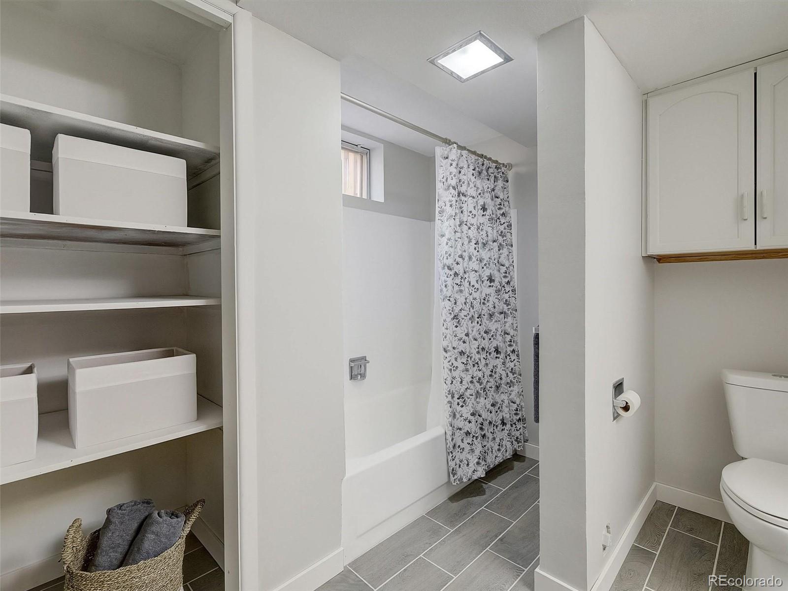 6432 South Birch Circle Centennial, CO 80121 - Photo 30 of 40 a bathroom with a toilet and a shower