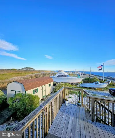 a view of a balcony with chair and wooden floor