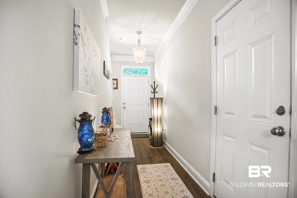 25806 Pollard Road, Unit 27 Daphne, AL 36526 - Photo 24 of 46 Doorway to outside featuring crown molding and wood finished floors