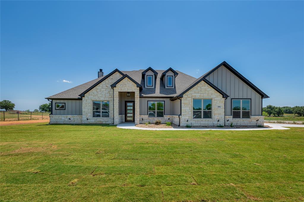 a front view of a house with swimming pool having outdoor seating