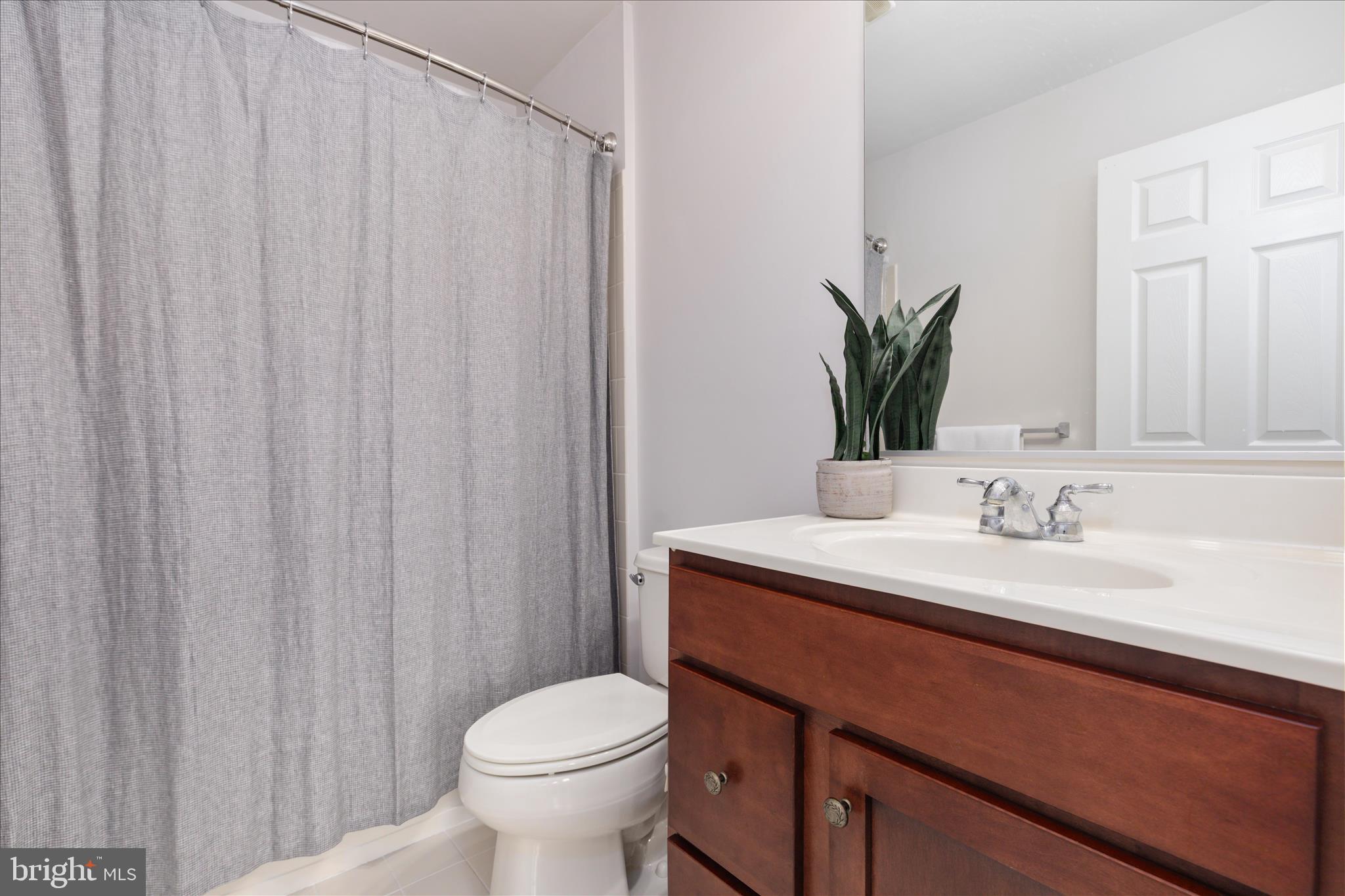 42824 Nations Street Chantilly, VA 20152 - Photo 19 of 26 a bathroom with a granite countertop sink and a mirror