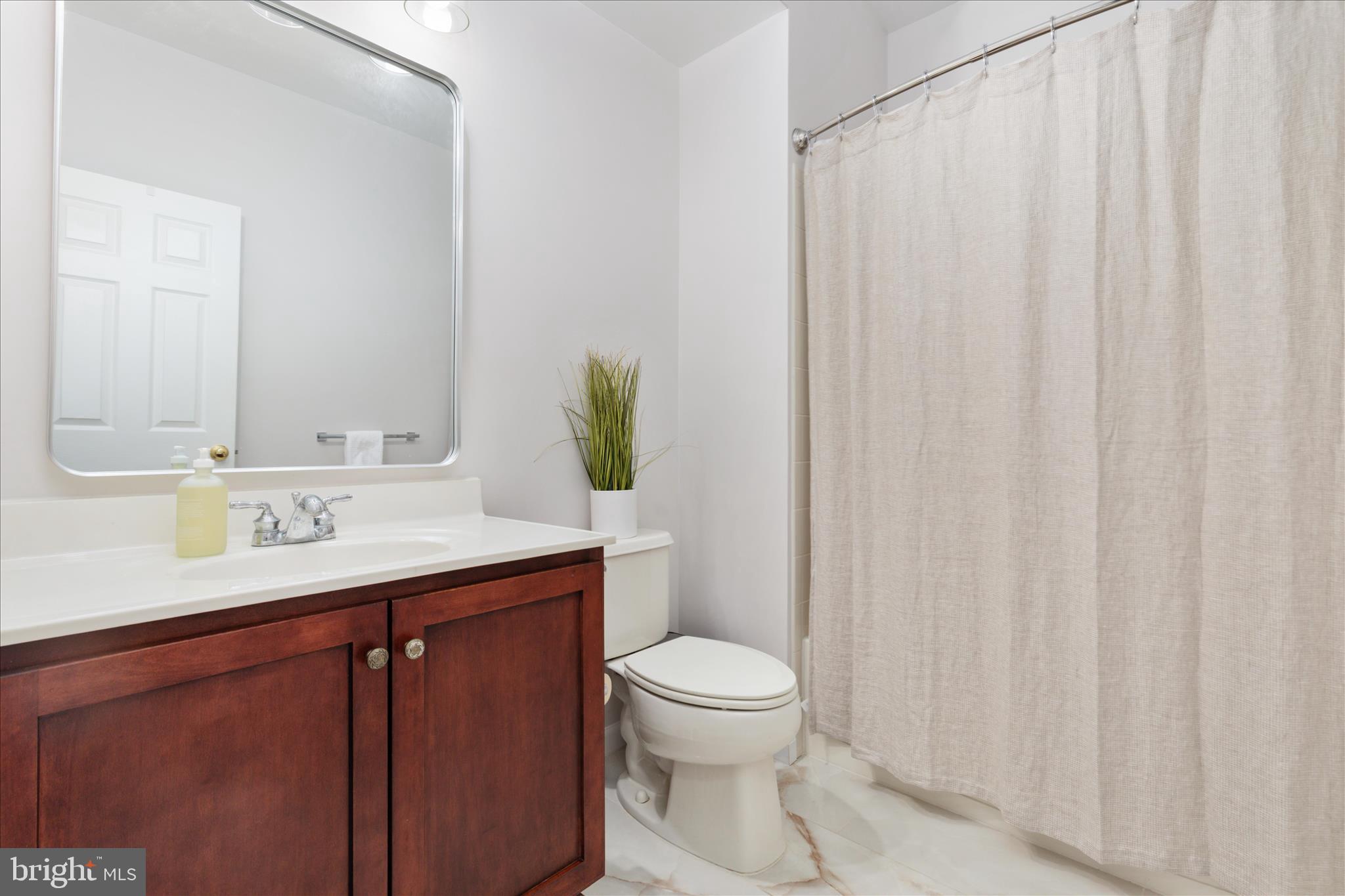 42824 Nations Street Chantilly, VA 20152 - Photo 23 of 26 a bathroom with a granite countertop sink and a mirror