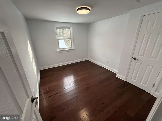 a view of room with wooden floor and fan