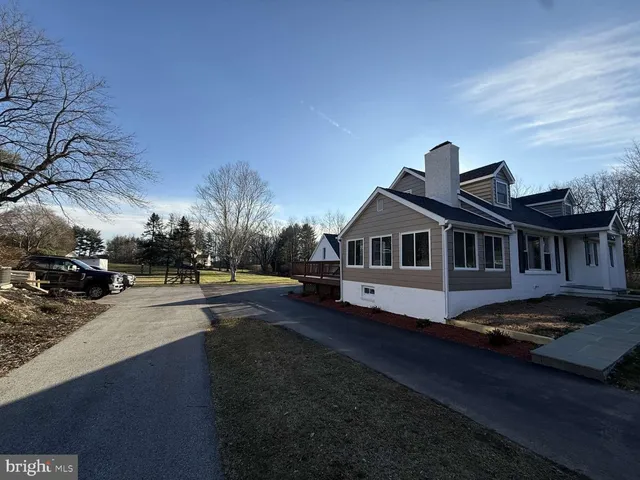 a front view of a house with yard and mountain view