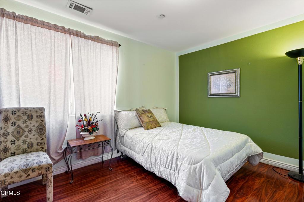 907 West Mission Road, Unit B Alhambra, CA 91801 - Photo 13 of 27 a bedroom with a bed and wooden floor