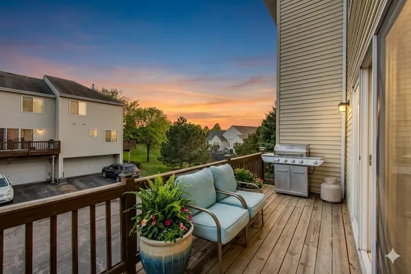 a view of a balcony with chairs and wooden floor