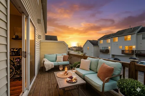 a view of city from balcony with seating space