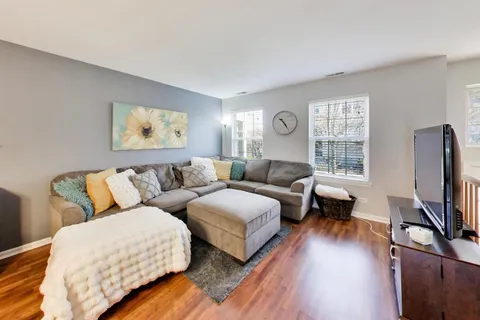 a living room with furniture flat screen tv and a window