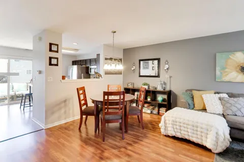 a view of a dining room with furniture and wooden floor